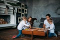 Happy family playing with toy railway road at home Royalty Free Stock Photo