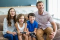 Happy family playing video games together in living room Royalty Free Stock Photo