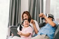 Happy family playing Virtual Reality game together, young kid girl using digital tablet, grandfather wearing VR headset Royalty Free Stock Photo