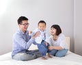 Happy family playing on white bed Royalty Free Stock Photo