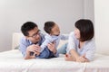 Happy family playing on white bed Royalty Free Stock Photo