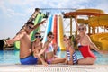 Happy family at poolside in water park Royalty Free Stock Photo