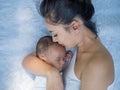 Happy family, portrait of beautiful young asian mother kissing her newborn baby with love. Healthcare and medical love Royalty Free Stock Photo