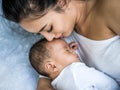 Happy family, portrait of beautiful young asian mother kissing her newborn baby with love. Healthcare and medical love Royalty Free Stock Photo