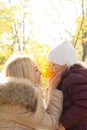 Happy family portrait, blonde mother and daughter speaking in autumn forest Royalty Free Stock Photo