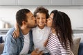 Happy Family Portrait. Closeup Of Loving Black Parents Kissing Their Preteen Son Royalty Free Stock Photo