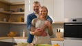 Happy family portrait at home cooking kitchen adult Caucasian couple lovely husband and wife man and woman spouses Royalty Free Stock Photo