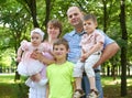 Happy family portrait on outdoor, group of five people posing in city park, summer season, child and parent Royalty Free Stock Photo