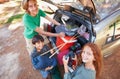 Happy family, portrait and packing car above for holiday, road trip or camping vacation together in nature. Top view of Royalty Free Stock Photo