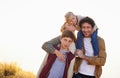 Happy family, portrait and smile with field, walk and sunrise for morning exercise and bond. Parents, children and Royalty Free Stock Photo