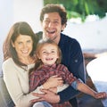 Happy family, portrait and smile in garden of home with embrace, relax and weekend break in summer. Parents, girl child Royalty Free Stock Photo