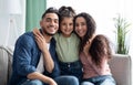 Happy Family Portrait. Smiling arabic parents and their little daughter posing together Royalty Free Stock Photo