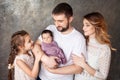 Happy family portrait.  Smiling parents with two children. Mother and father with newborn baby and toddler girl. Concept of  happy Royalty Free Stock Photo