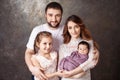 Happy family portrait.  Smiling parents with two children. Mother and father with newborn baby and toddler girl. Concept of  happy Royalty Free Stock Photo