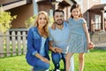 Happy family posing near their new house Royalty Free Stock Photo