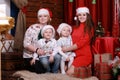 Happy family posing for photo at christmas. grandmother and mother with two children in santa hats