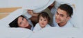 Attractive young family in the bedroom Royalty Free Stock Photo