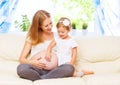 Happy family. Pregnant mother and baby daughter having fun relax Royalty Free Stock Photo