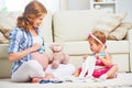 Happy family pregnant mother and child preparing clothing for ne Royalty Free Stock Photo