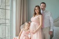 Happy family. Pregnant mother, father and child daughter at home Royalty Free Stock Photo