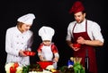 Happy family preparing breakfast together. Homemade food. Parents teaching little boy to cook healthy food. Mother Royalty Free Stock Photo