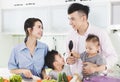 Happy family preparing dinner with healthy  food in kitchen Royalty Free Stock Photo