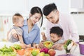 Happy family preparing dinner with healthy  food in kitchen Royalty Free Stock Photo