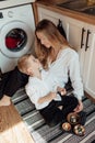 Happy family preparing Easter eggs indoors. Mother and boy celebrating happy Easter holiday together at home Royalty Free Stock Photo