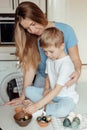 Happy family preparing Easter eggs indoors. Mother and boy celebrating happy Easter holiday together at home Royalty Free Stock Photo