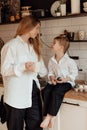 Happy family preparing Easter eggs indoors. Mother and boy celebrating happy Easter holiday together at home Royalty Free Stock Photo