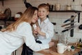 Happy family preparing Easter eggs indoors. Mother and boy celebrating happy Easter holiday together at home Royalty Free Stock Photo