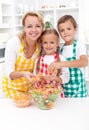 Happy family preparing fresh salad