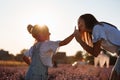 Happy family in purple lavender field. young beautiful mother and child Girl enjoy walking blooming meadow on summer day Royalty Free Stock Photo