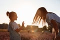 Happy family in purple lavender field. young beautiful mother and child Girl enjoy walking blooming meadow on summer day Royalty Free Stock Photo