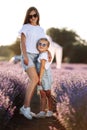 Happy family in purple lavender field. young beautiful mother and child Girl enjoy walking blooming meadow on summer day Royalty Free Stock Photo