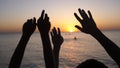 Happy family raising hands up. Hands up in the air silhouette over sunset sky. Royalty Free Stock Photo