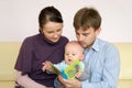 Happy family reading a book