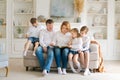 Happy family reading book at home. Mom and dad and young children sit together Royalty Free Stock Photo