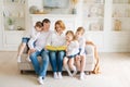 Happy family reading book at home. Mom and dad and young children sit together Royalty Free Stock Photo