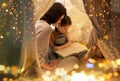 Happy family reading book in kids tent at home Royalty Free Stock Photo