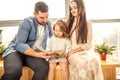 Happy family reading a book to her daughter. Royalty Free Stock Photo