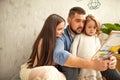 Happy family reading a book to her daughter. Mothers Day. Royalty Free Stock Photo