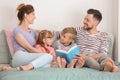 Happy family reading book together at home Royalty Free Stock Photo