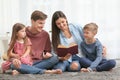 Happy family reading book together at home Royalty Free Stock Photo