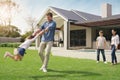Happy family, real estate and playing on grass together from holiday, weekend or break in the outdoors. Father swinging Royalty Free Stock Photo