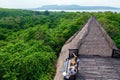 Happy family relaxing in lounge above tropical jungle