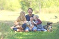Happy Family Relaxing Outside with Dog Royalty Free Stock Photo