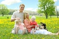 Happy Family Relaxing Outside in Field of Flowers with Dog Royalty Free Stock Photo