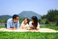 Happy family relaxing and playing outdoor together in park on weekend Royalty Free Stock Photo