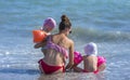 Young mother and her two adorable little daughter